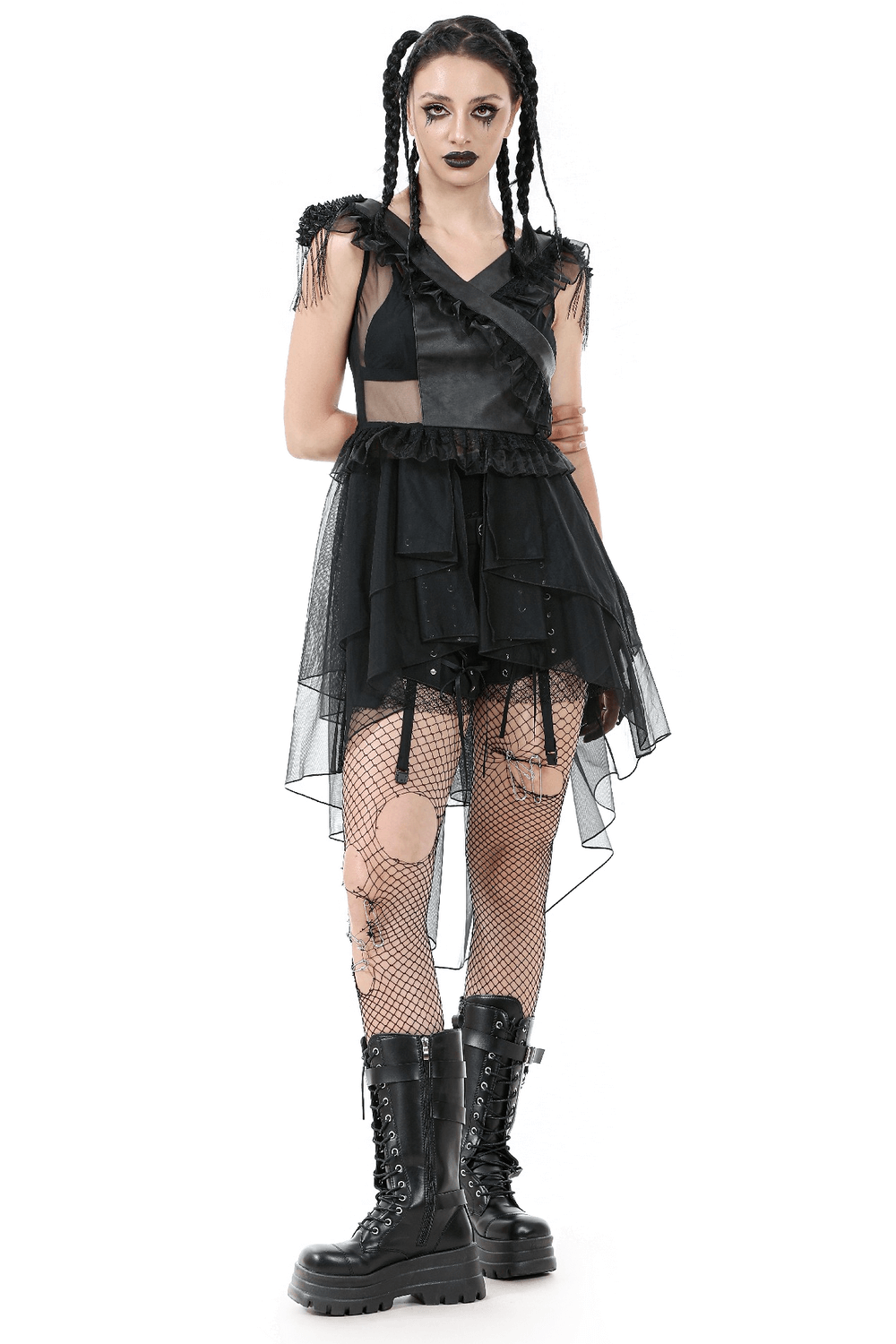 Gothic lace-up tiered tulle dress with ruffles, worn with fishnet tights and chunky boots, perfect for dark fashion enthusiasts.