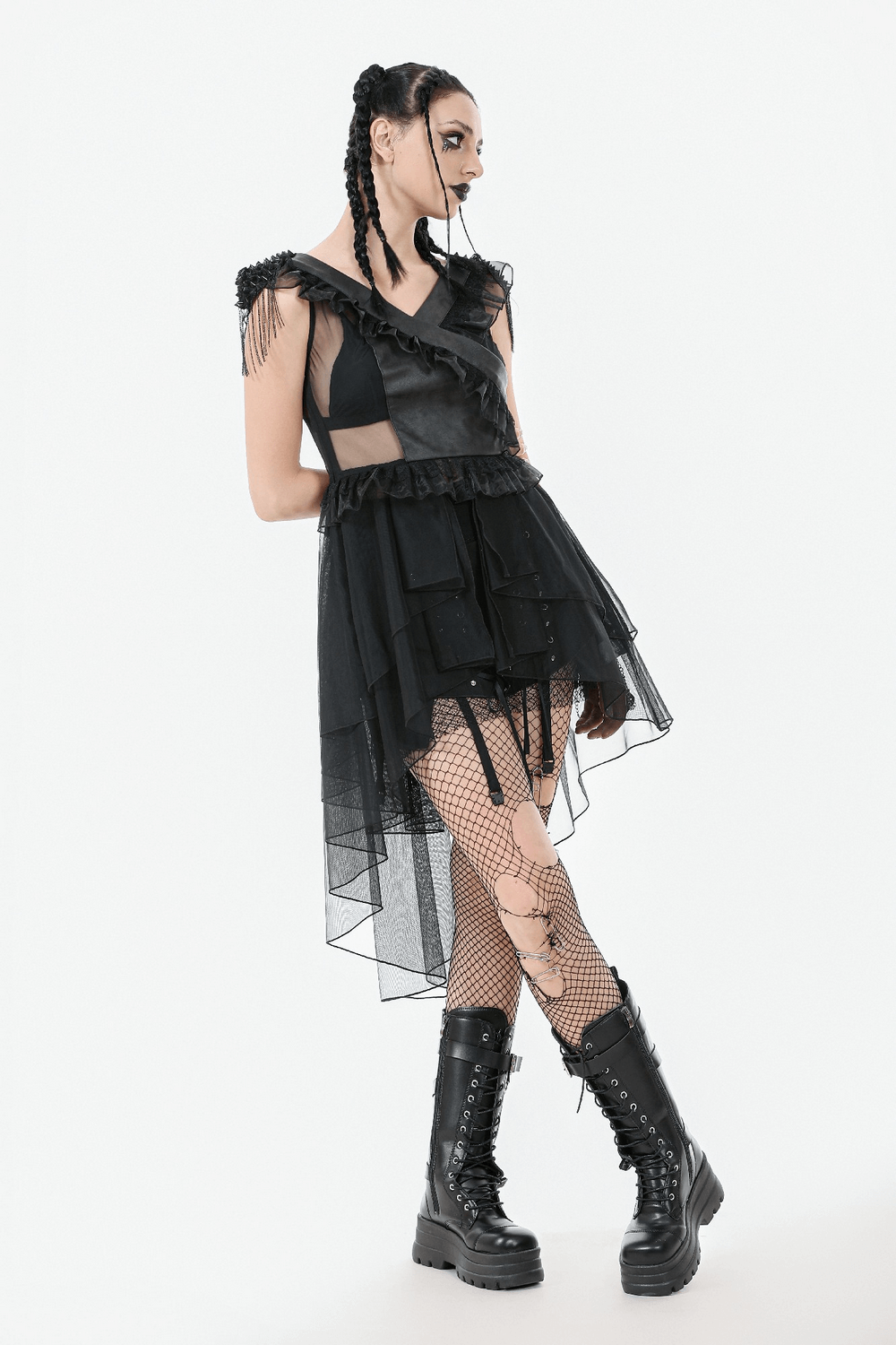 Gothic female lace-up tiered tulle dress with ruffles and edgy black boots, showcasing a dark romantic style.