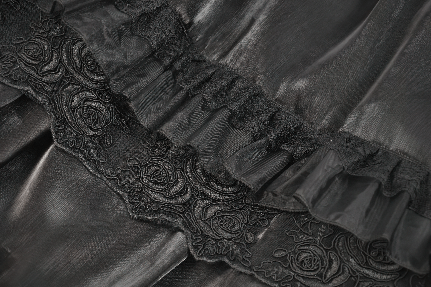 Female Layered Black Lace Mesh Skirt with Ruffled Tiers features intricate floral embroidery and cascading ruffles.