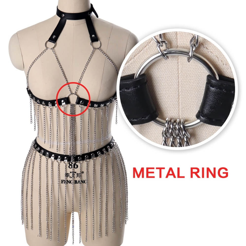 Female leather body harness with hanging chains, metal ring detail, gothic fashion festival accessory.