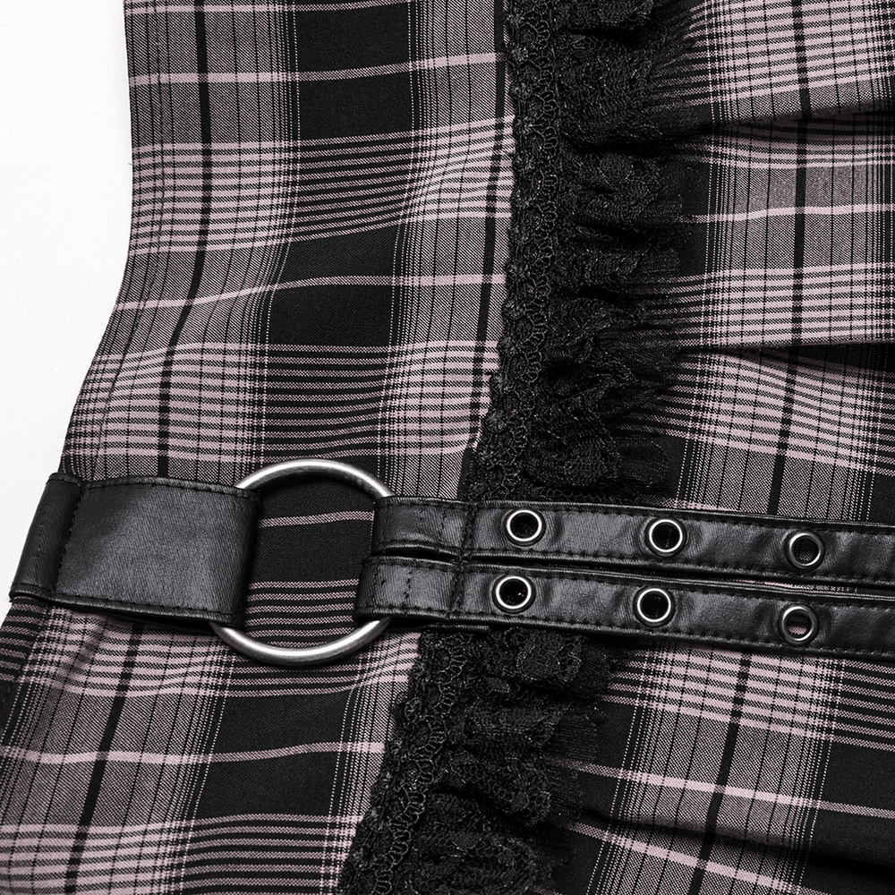Close-up of black and pink plaid mini skirt with faux leather detail and lace trim, showcasing edgy design elements.