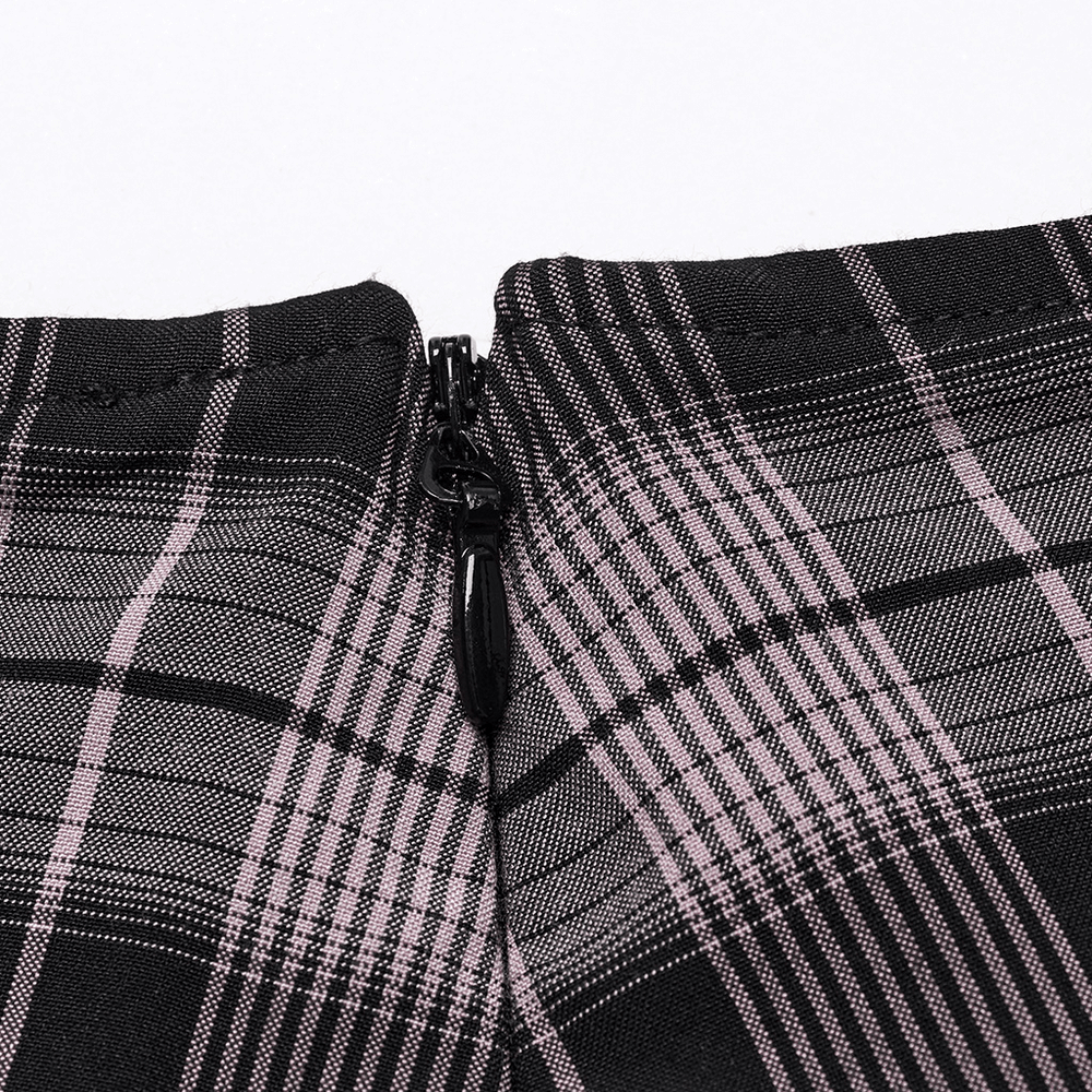 Close-up view of the invisible side zipper on a black and pink plaid mini skirt.