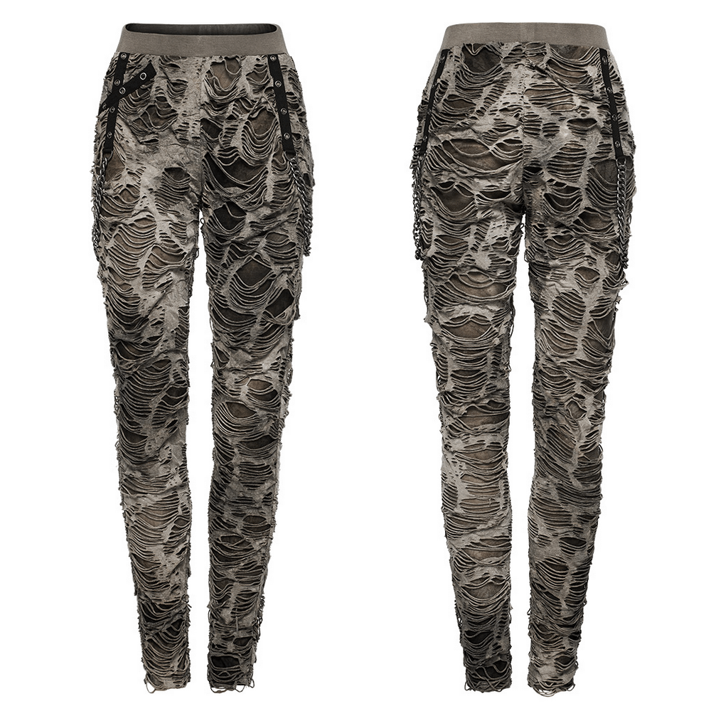 Female ripped skinny trousers with chain detailing, showcasing edgy punk-inspired fashion.