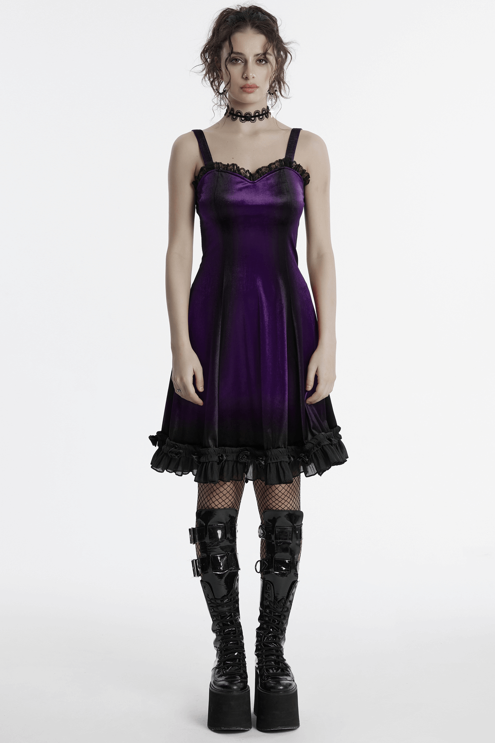 Gothic female sleeveless velvet dress in purple with lace and ruffle hem, paired with stylish knee-high boots.