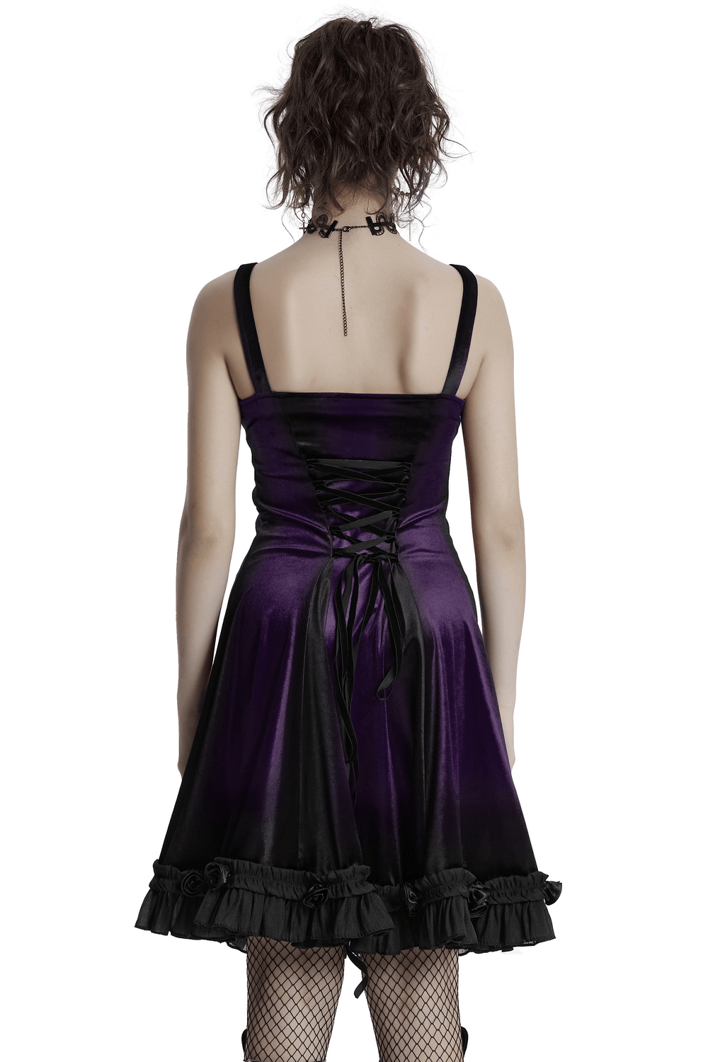 Back view of a female in a goth velvet dress with adjustable corset and ruffled hem.