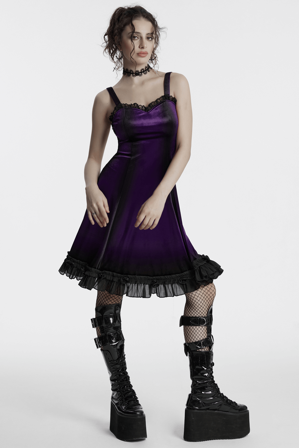 Goth sleeveless velvet dress in gradient purple with lace and ruffle hem, styled with platform boots and fishnet stockings.