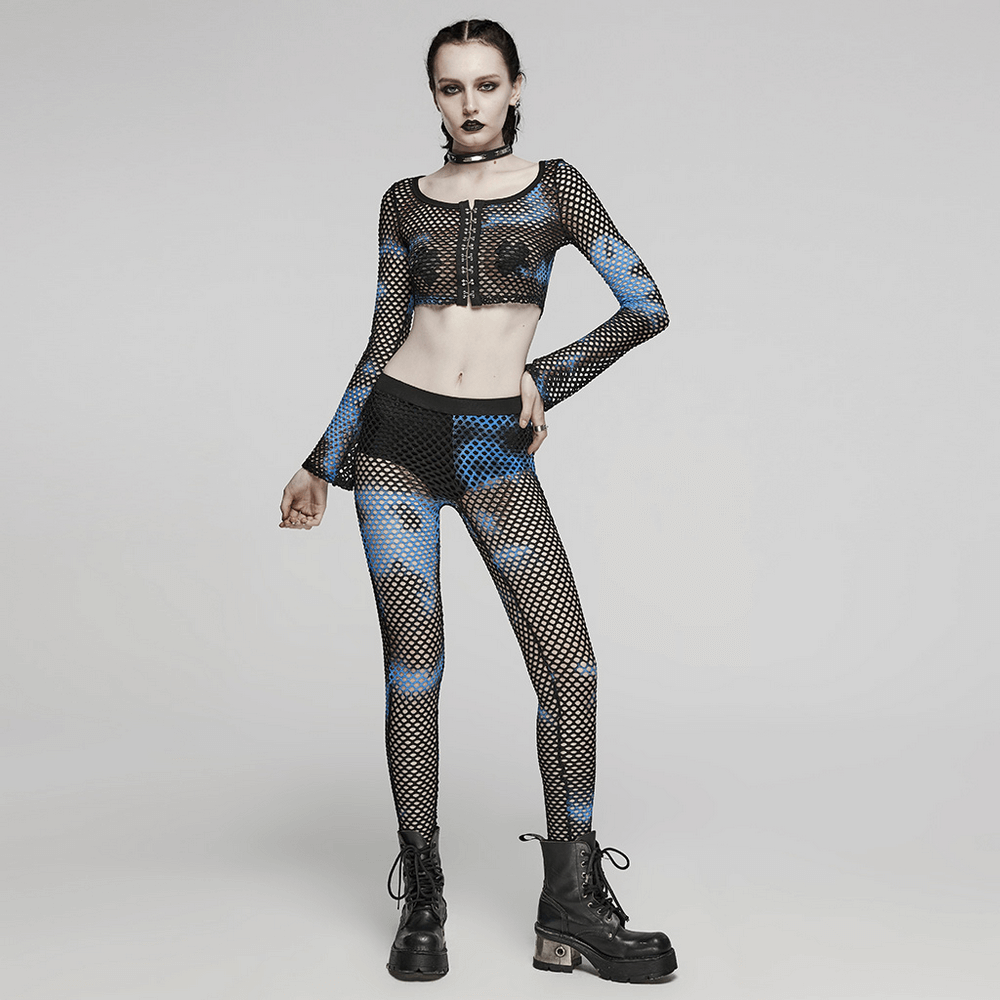 Edgy female model in black-blue fishnet mesh leggings and crop top, showcasing punk streetwear style.