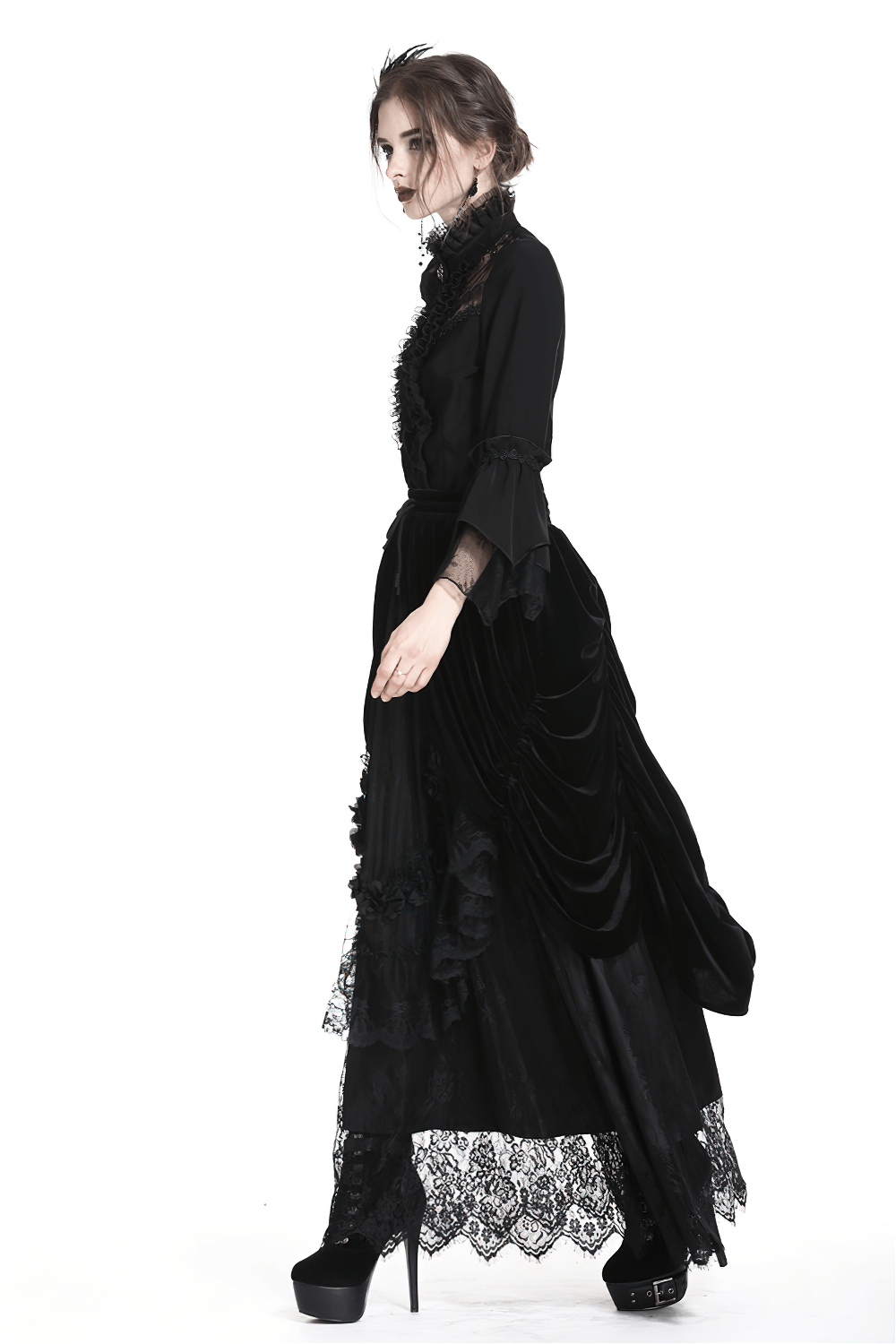 Elegant female model in a flowy black velvet gothic maxi skirt with lace trim, embodying dark romantic style.