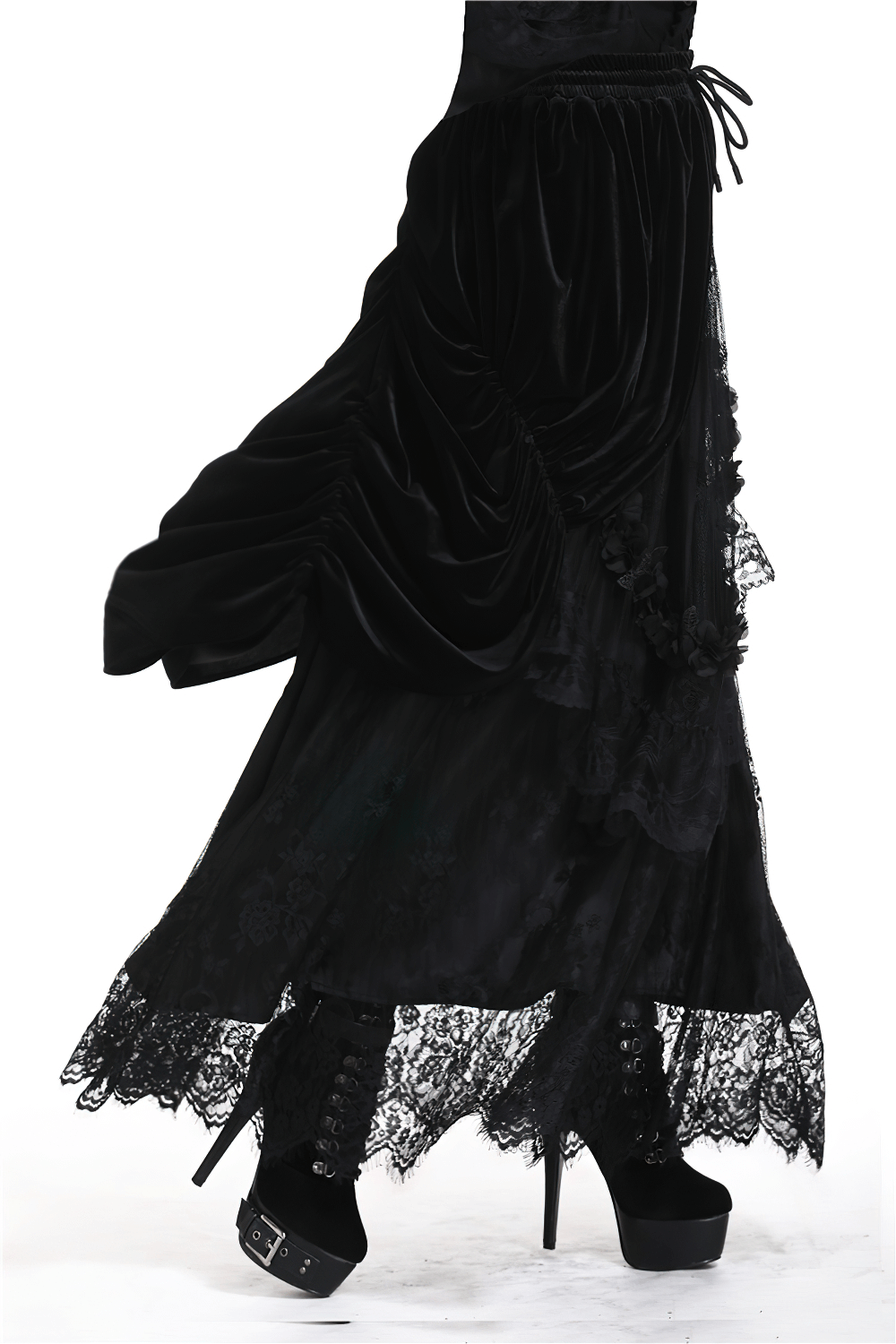 Flowy black velvet gothic maxi skirt with dramatic lace trim, paired with stylish lace-up platform boots.