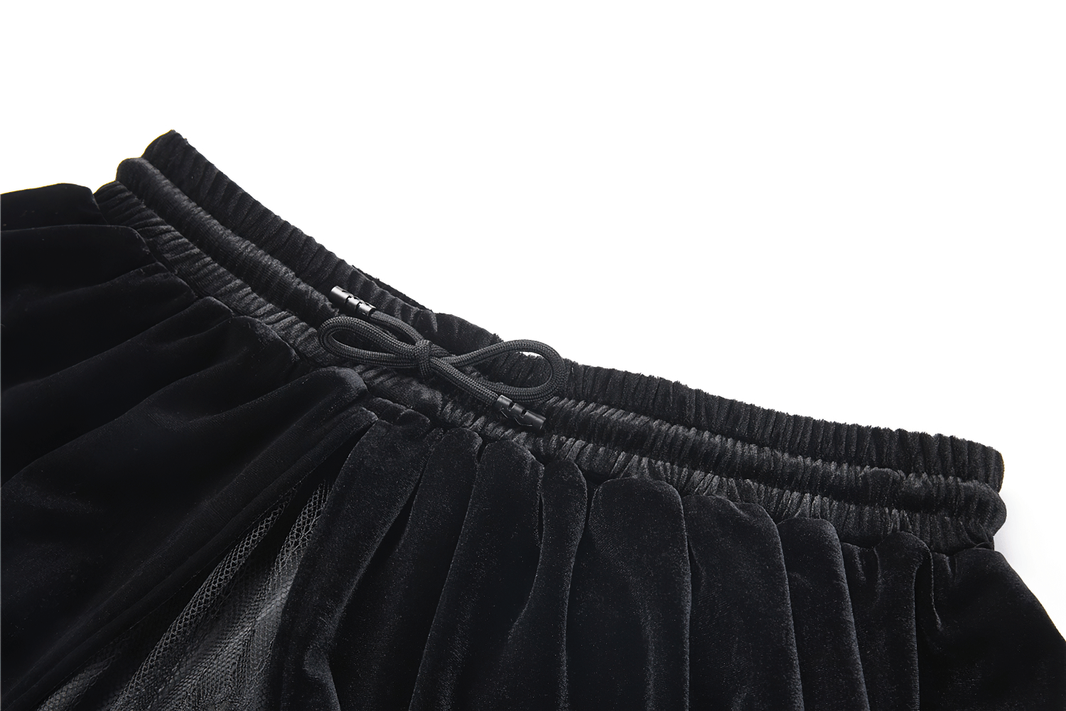 Close-up of the waistband of a black velvet gothic maxi skirt with lace trim, featuring a stylish tie accent.