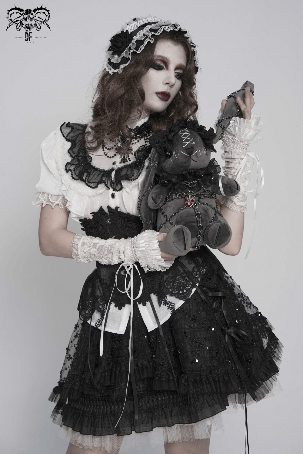 Female Victorian Blouse with Black Lace-Up Corset Back worn by model holding plush teddy bear.