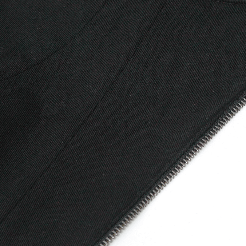 Close-up of black textured fabric with a zipper detail, showcasing stylish gothic fashion design.