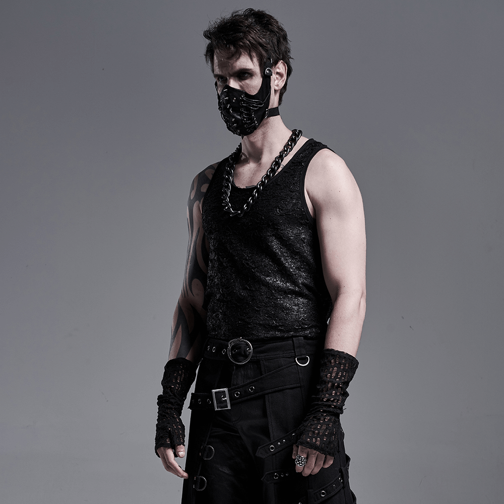 Edgy gothic style man wearing fingerless mesh gloves and a matching mask, showcasing a bold fashion statement.