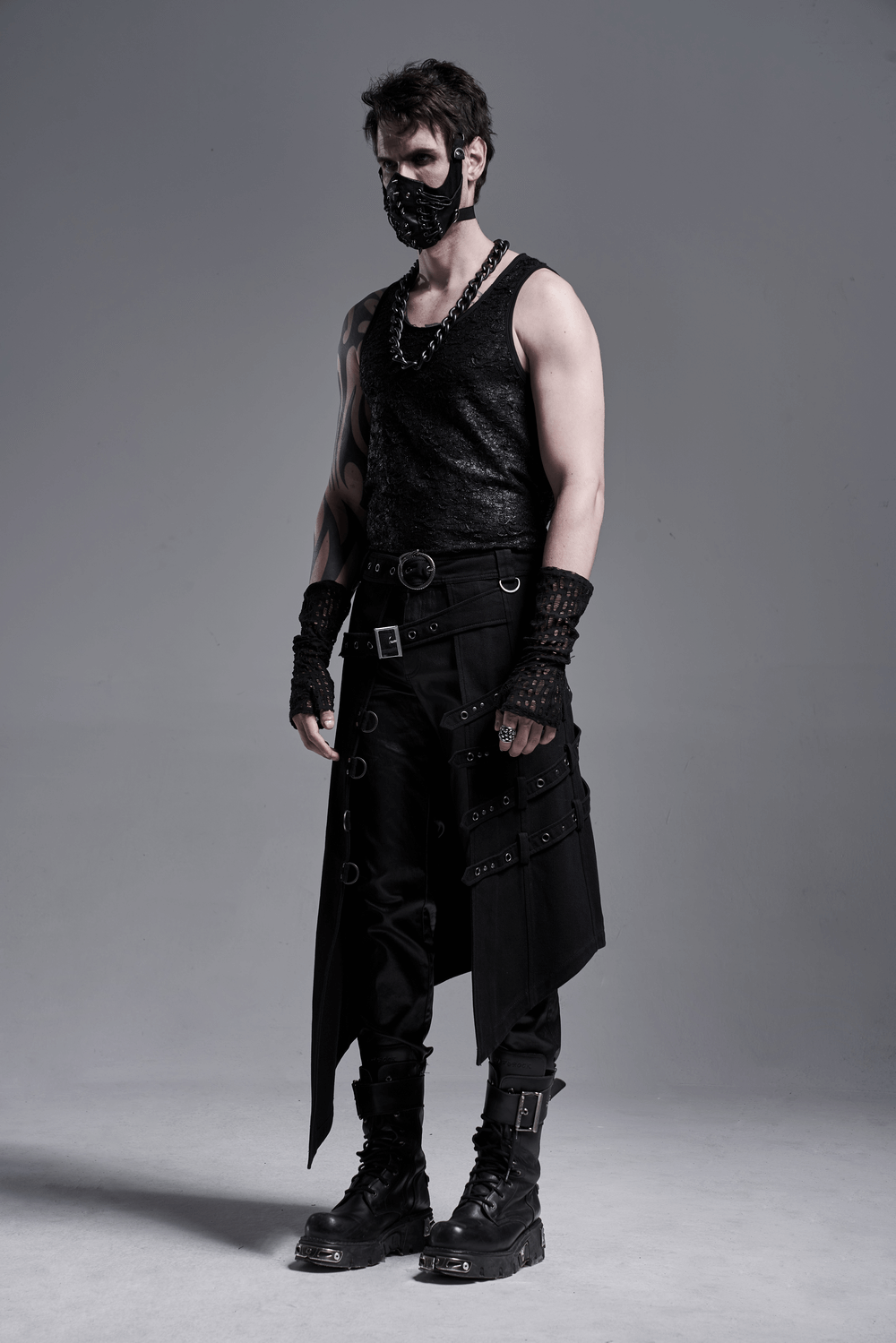 Gothic fashion model in fingerless gloves, showcasing edgy style with black attire and accessories, exuding dark elegance.