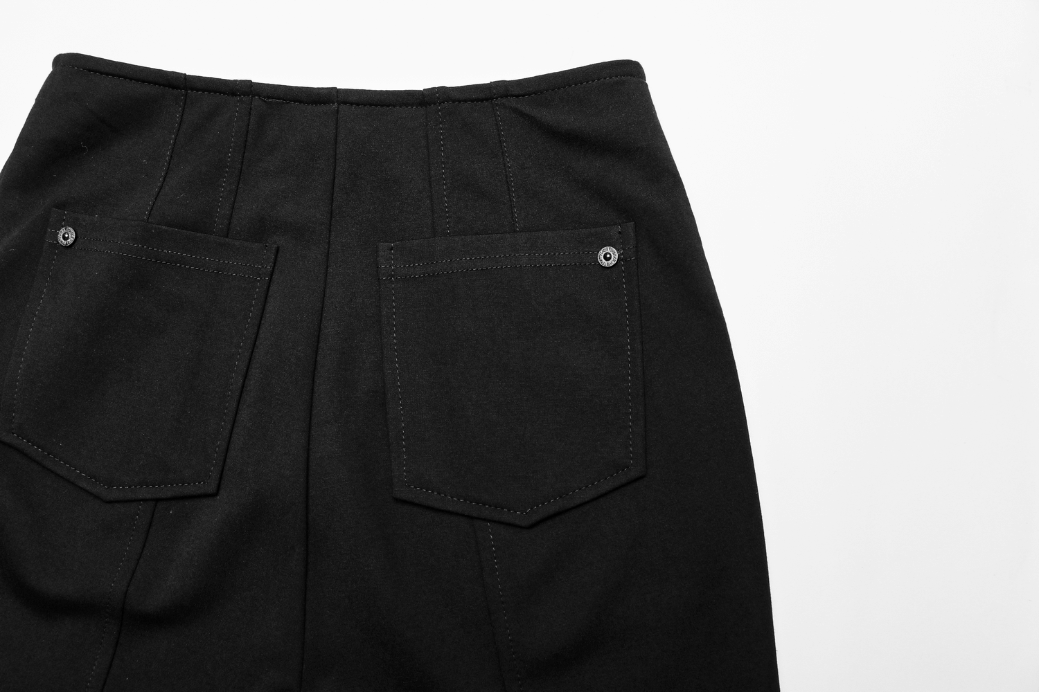 Back view of high-waisted black flare pants featuring buttoned pockets and stylish seam details.