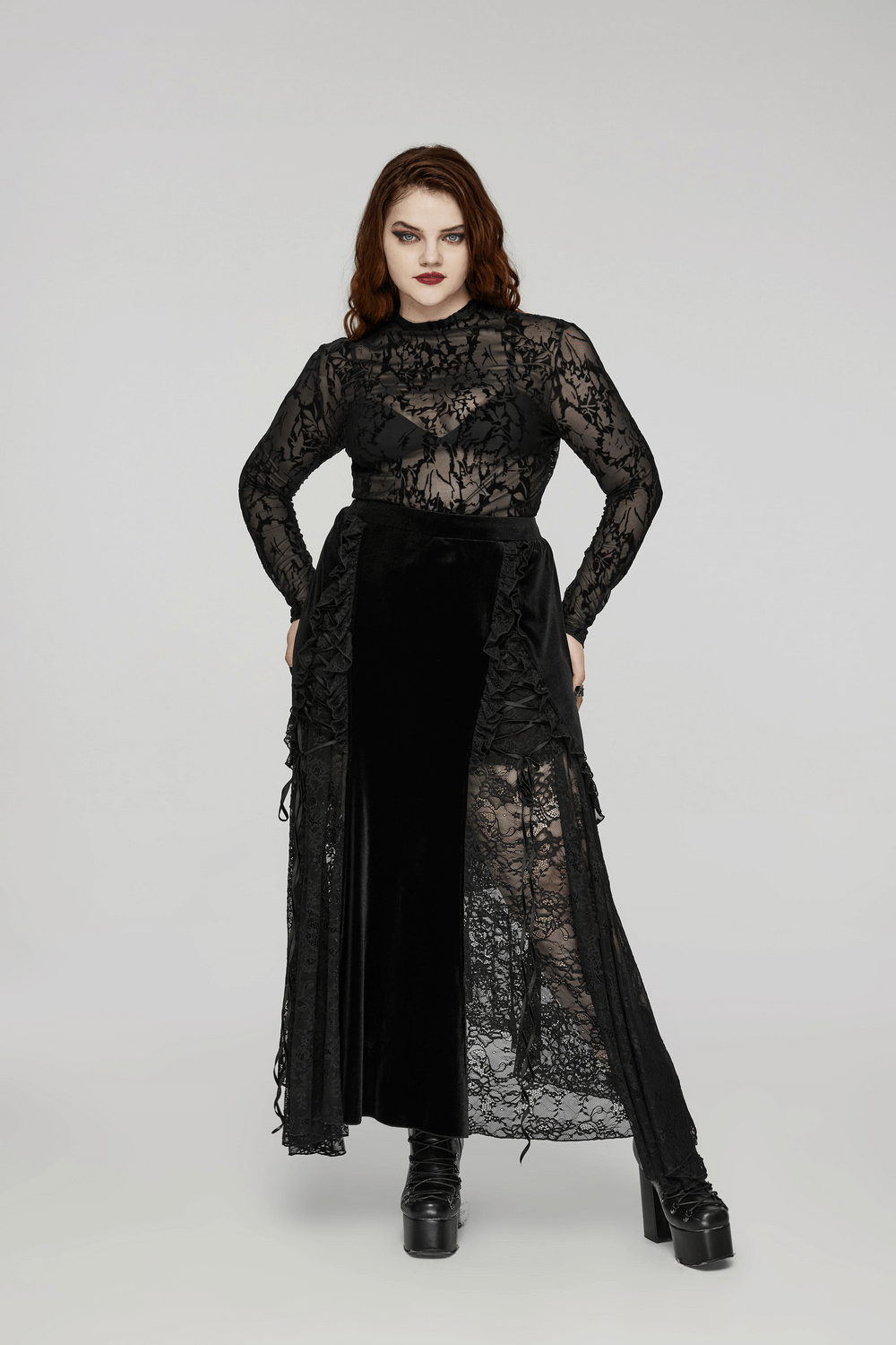 Chic model wearing a floral flocked mesh long sleeve top with a gothic charm and elegant black skirt.