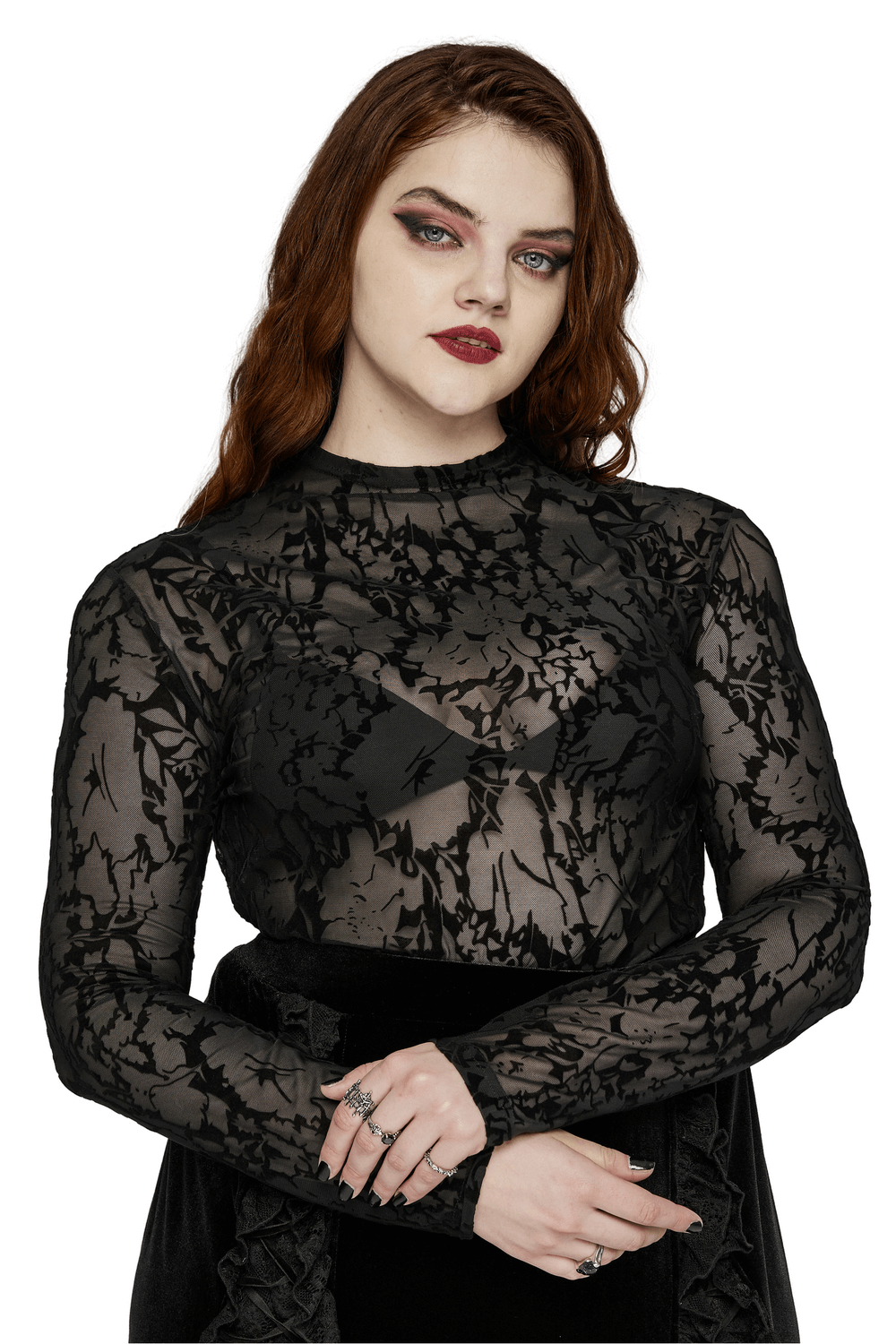 Chic model wearing a floral flocked mesh long sleeve top with gothic elegance and a striking silhouette.