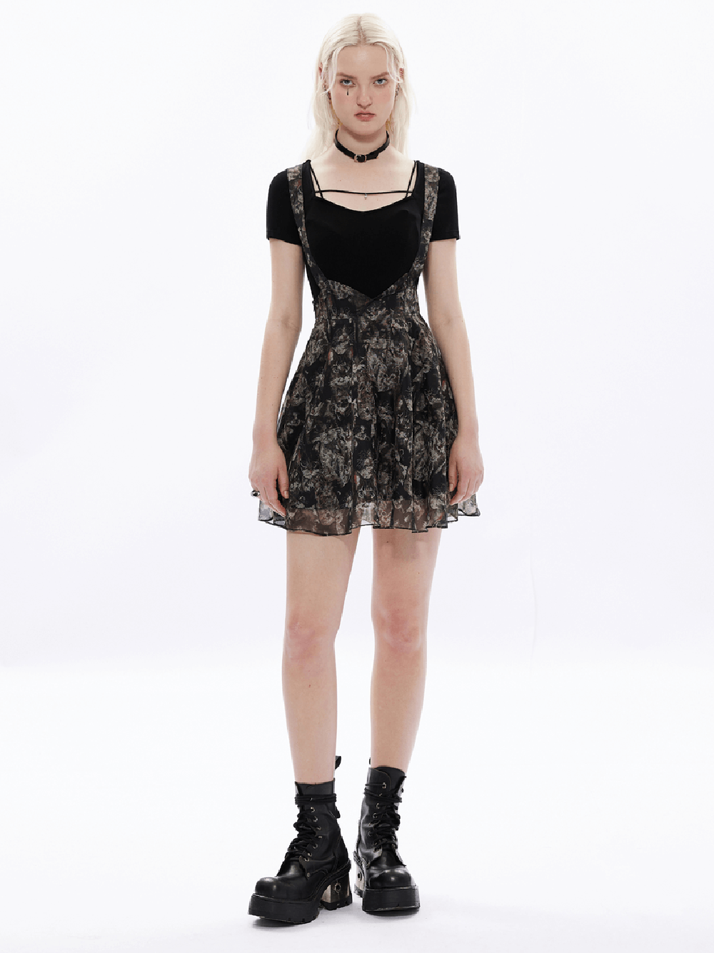 Model wearing a floral print A-line skirt with cat-ear straps and a black top, showcasing a playful and whimsical style.