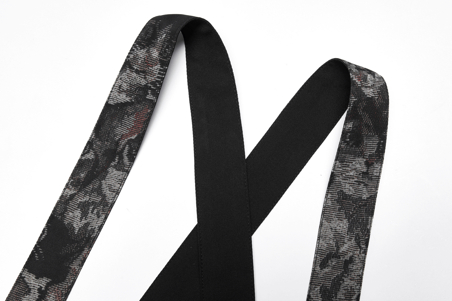 Cross-back straps of a floral print A-line skirt showcasing a stylish pattern and chic black detailing.