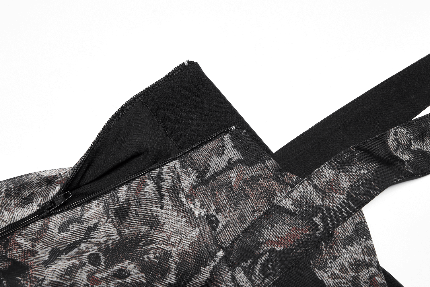 Close-up of floral print and cat-ear straps on an A-line skirt, showcasing criss-cross back design.