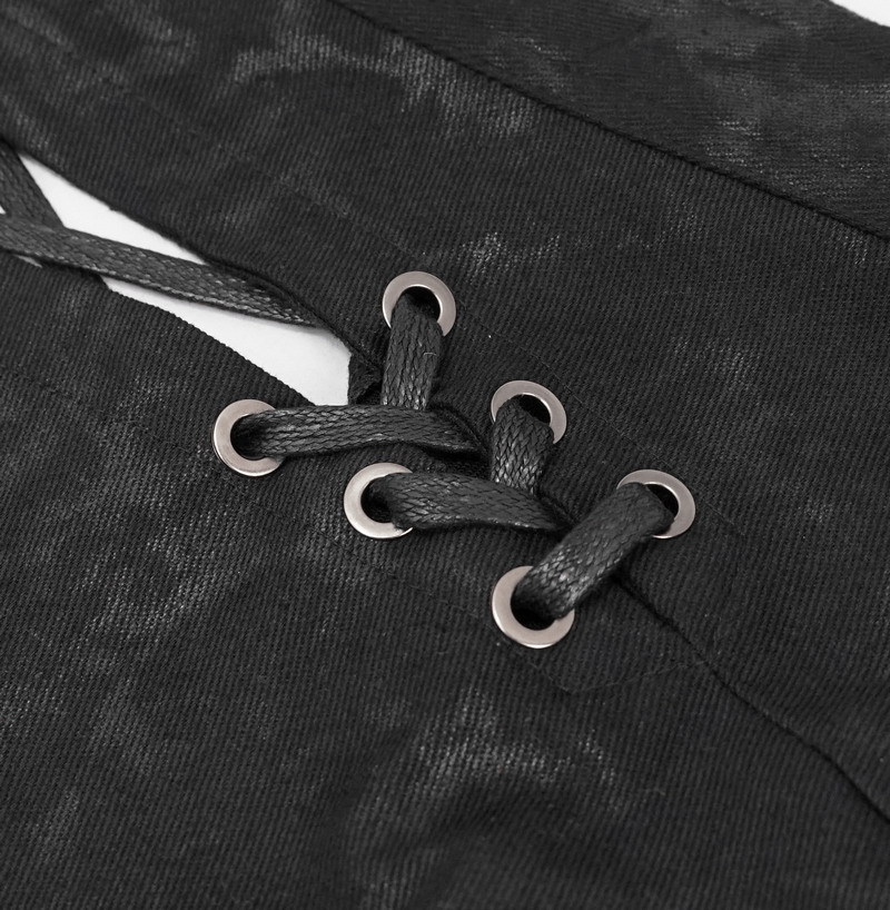 Close-up of decorative lacing on a men's kilt in black fabric, showcasing stylish details.