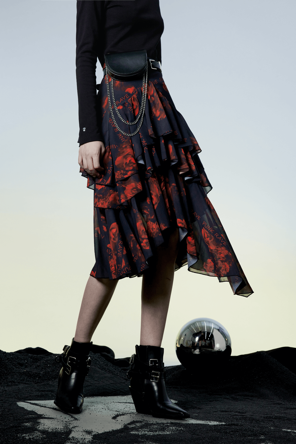 Flowy Punk Rave high-low floral skirt with layered ruffles, showcasing an edgy style against a dramatic backdrop.
