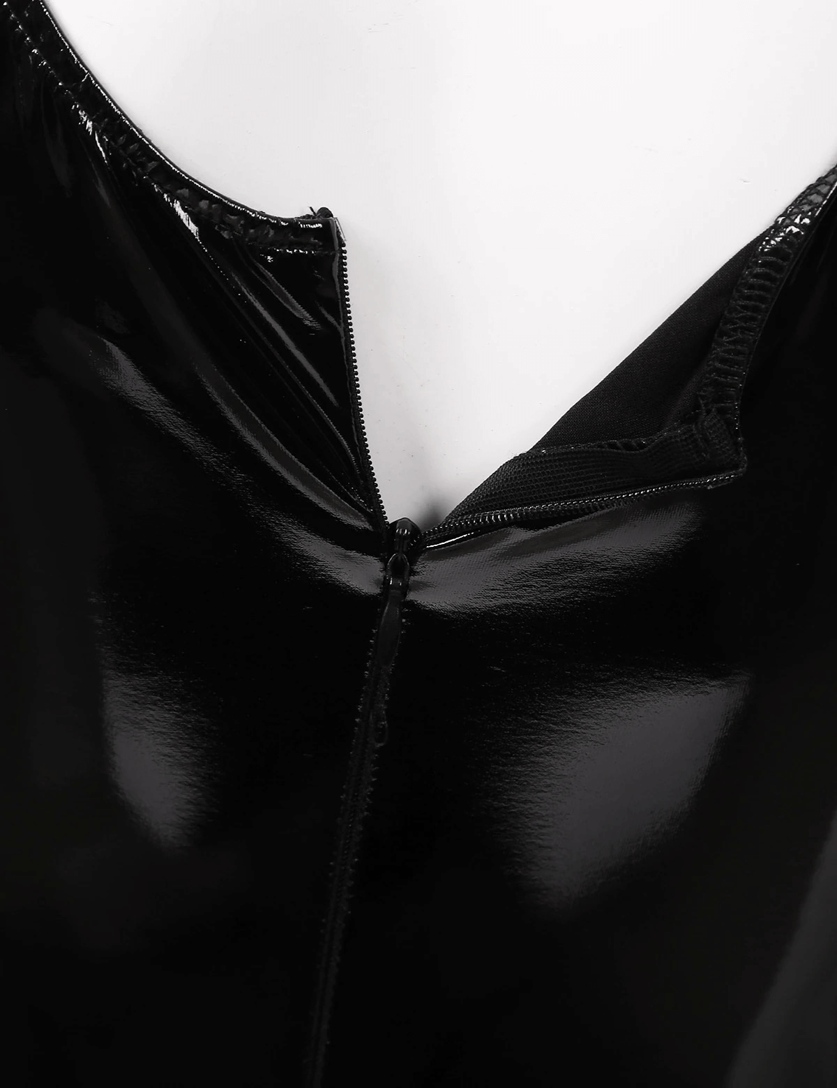 Close-up of women's black patent leather jumpsuit with U-neckline and zip detail