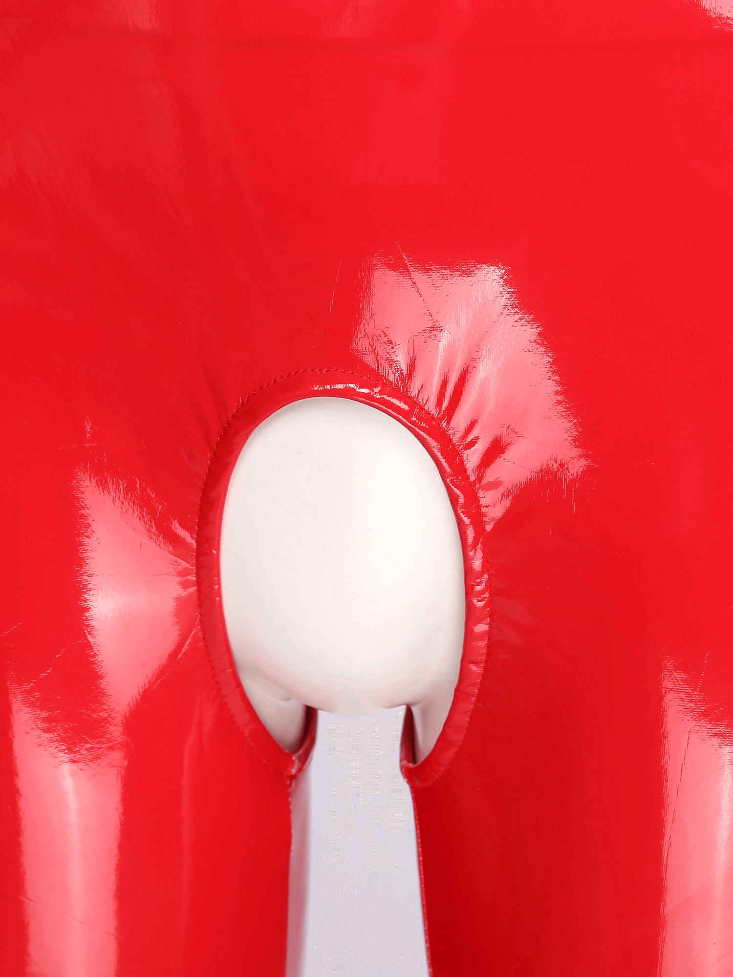 Close-up of a red crotchless catsuit showcasing glossy patent finish and unique cutout design.