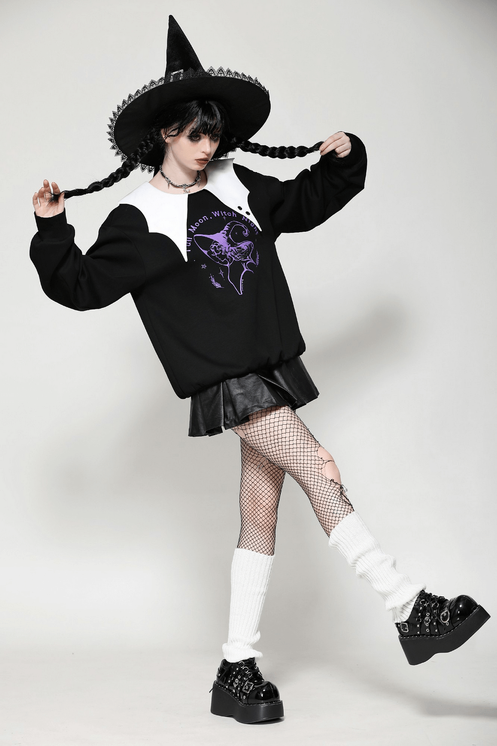 Model wearing Full Moon Witch graphic sweatshirt with Peter Pan collar, paired with a stylish black skirt and witch hat.