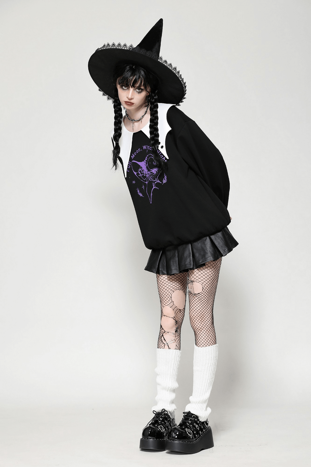 A model wearing a gothic Full Moon Witch sweatshirt with a contrast collar, paired with a black skirt and witch hat.