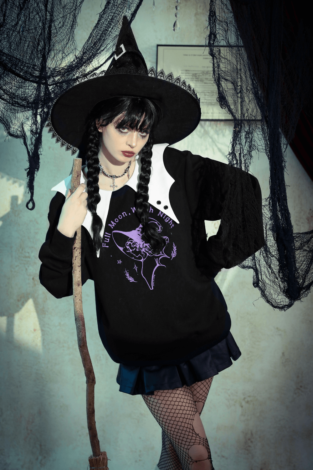 Full Moon Witch graphic sweatshirt with Peter Pan collar, styled for gothic fashion in a spooky setting.