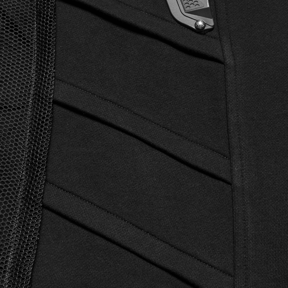 Close-up of the sleek black fabric and 3D rubber armor details on a futuristic cyberpunk vest for men.