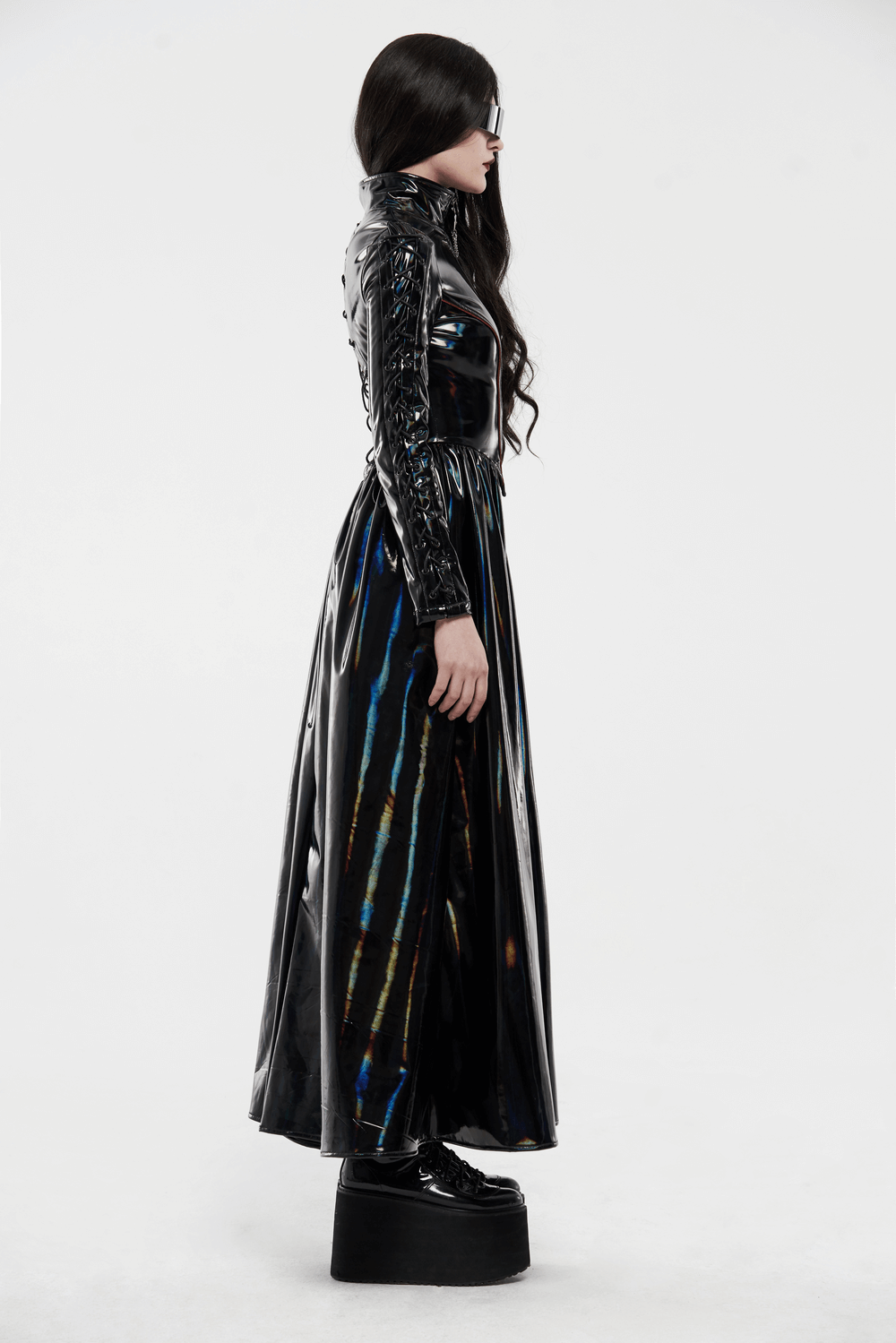 Futuristic high-shine laser-cut long coat for women in black with unique design and elegant details.