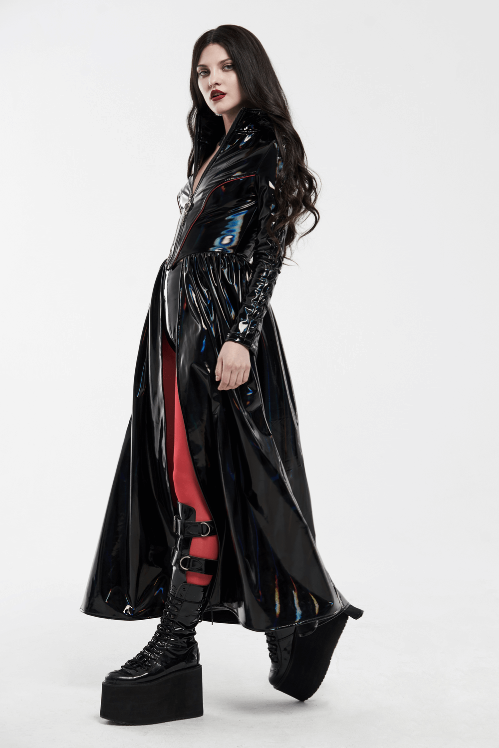 Futuristic high-shine laser-cut long coat for women, featuring sleek black fabric and edgy red accents.