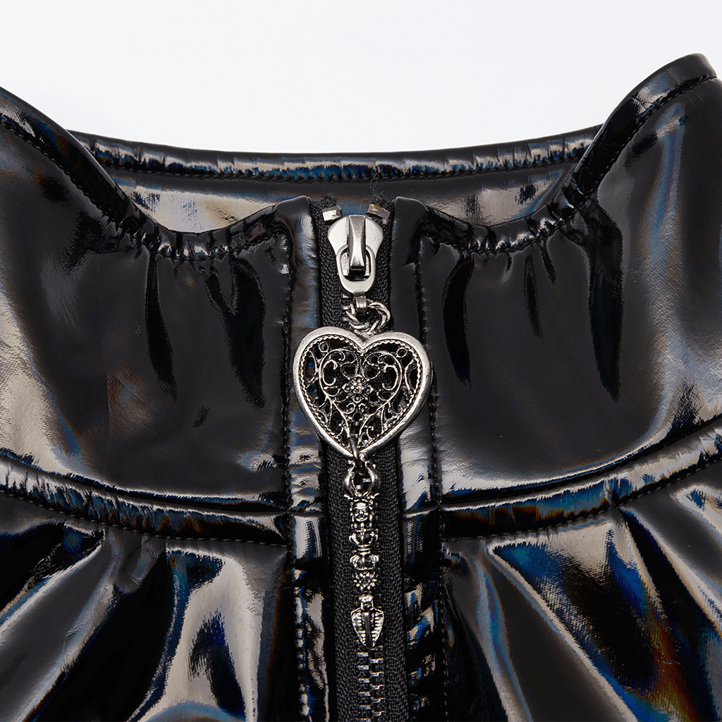Close-up of heart pendant zipper on futuristic high-shine laser-cut coat for women, showcasing avant-garde fashion details.