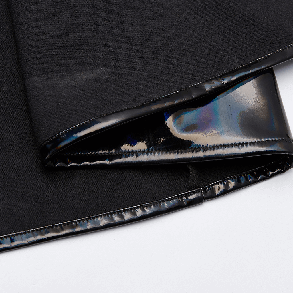 Close-up of the shiny laser-cut fabric and hem of a futuristic long coat for women.