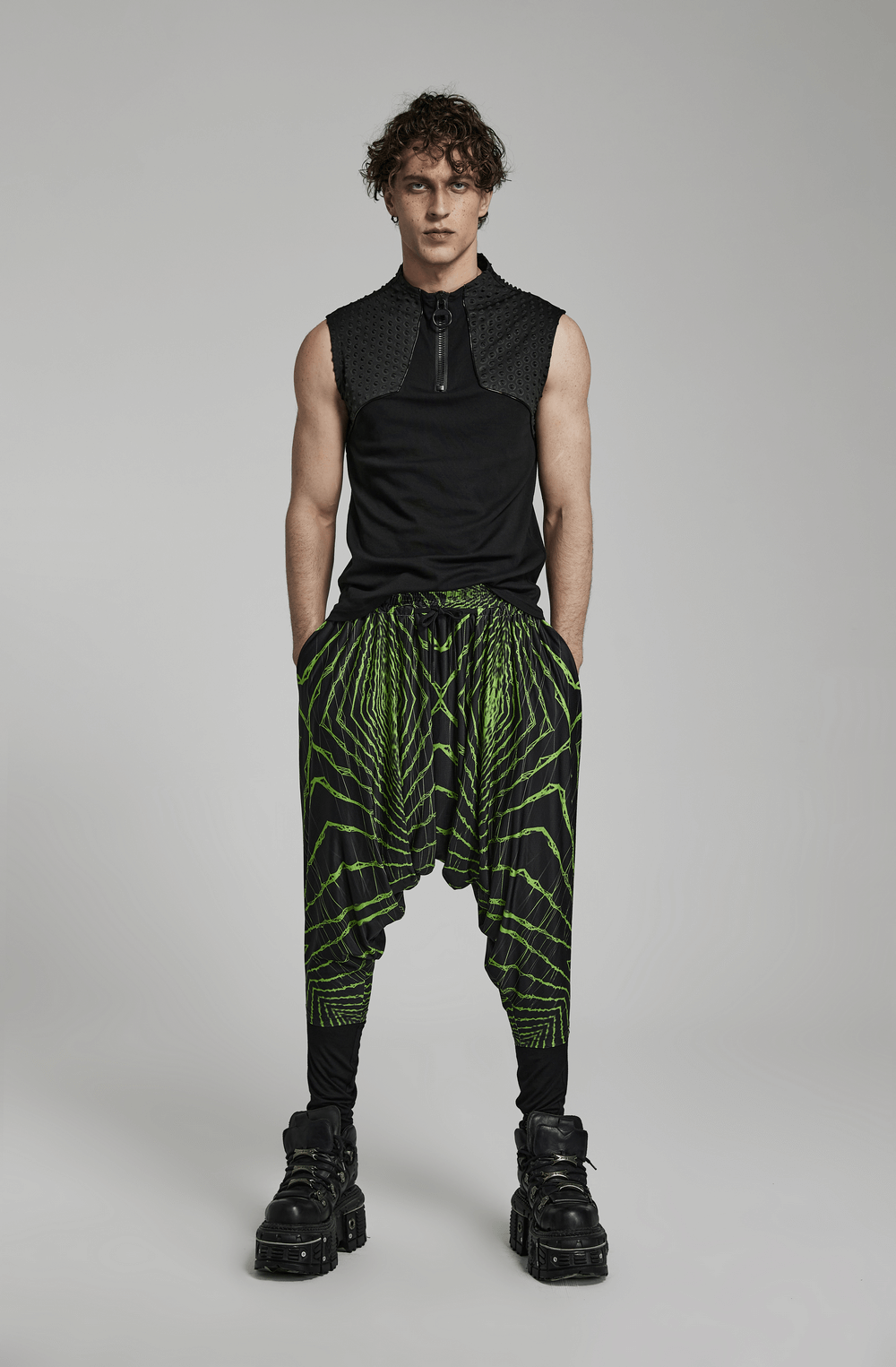 Stylish man in futuristic lightwave harem pants with geometric print and elastic waist for a streetwear look.
