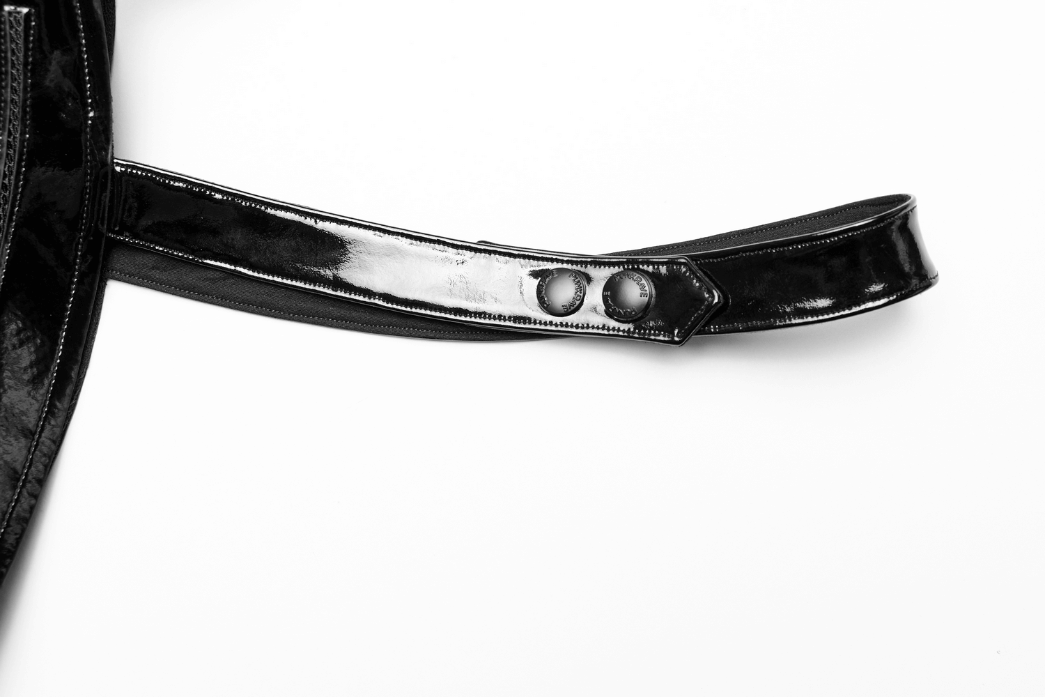 Close-up of glossy patent leather one-arm accessory with adjustable snap buttons.