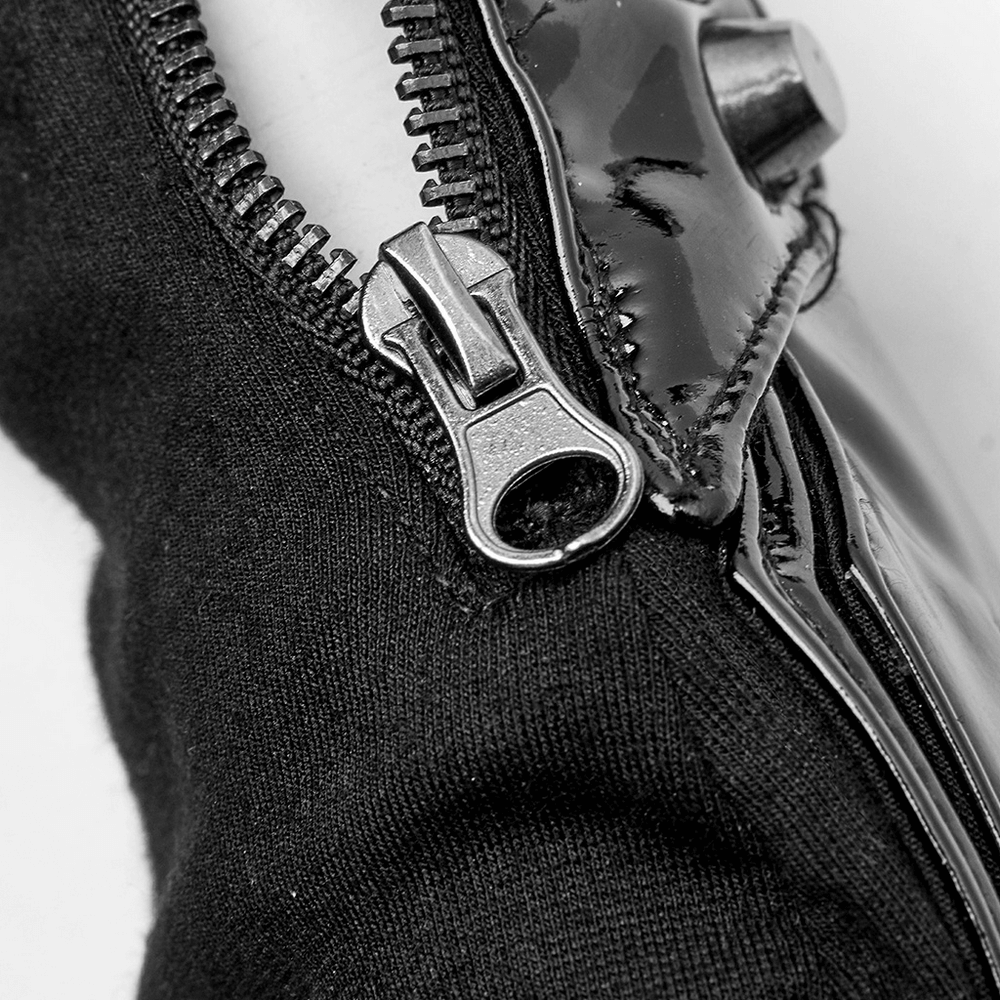 Close-up of zipper detail on futuristic punk half-finger gloves with metal rivets and sleek design.