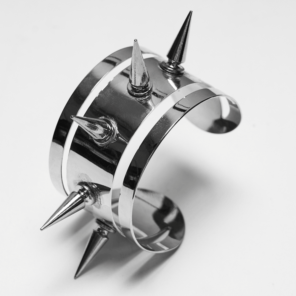 Futuristic Punk Spiked Arm Cuff with Mirror Finish showcasing sharp spikes and polished metallic design.