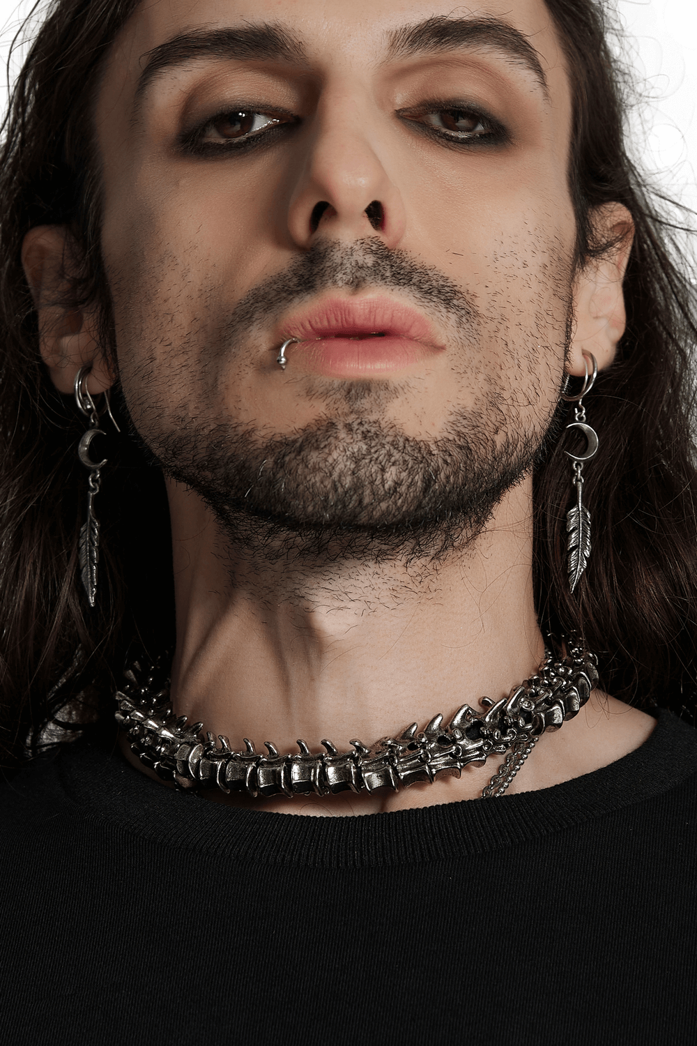 Close-up of a model showcasing a magnetic punk spine choker and feather earrings, exuding retro apocalypse style.