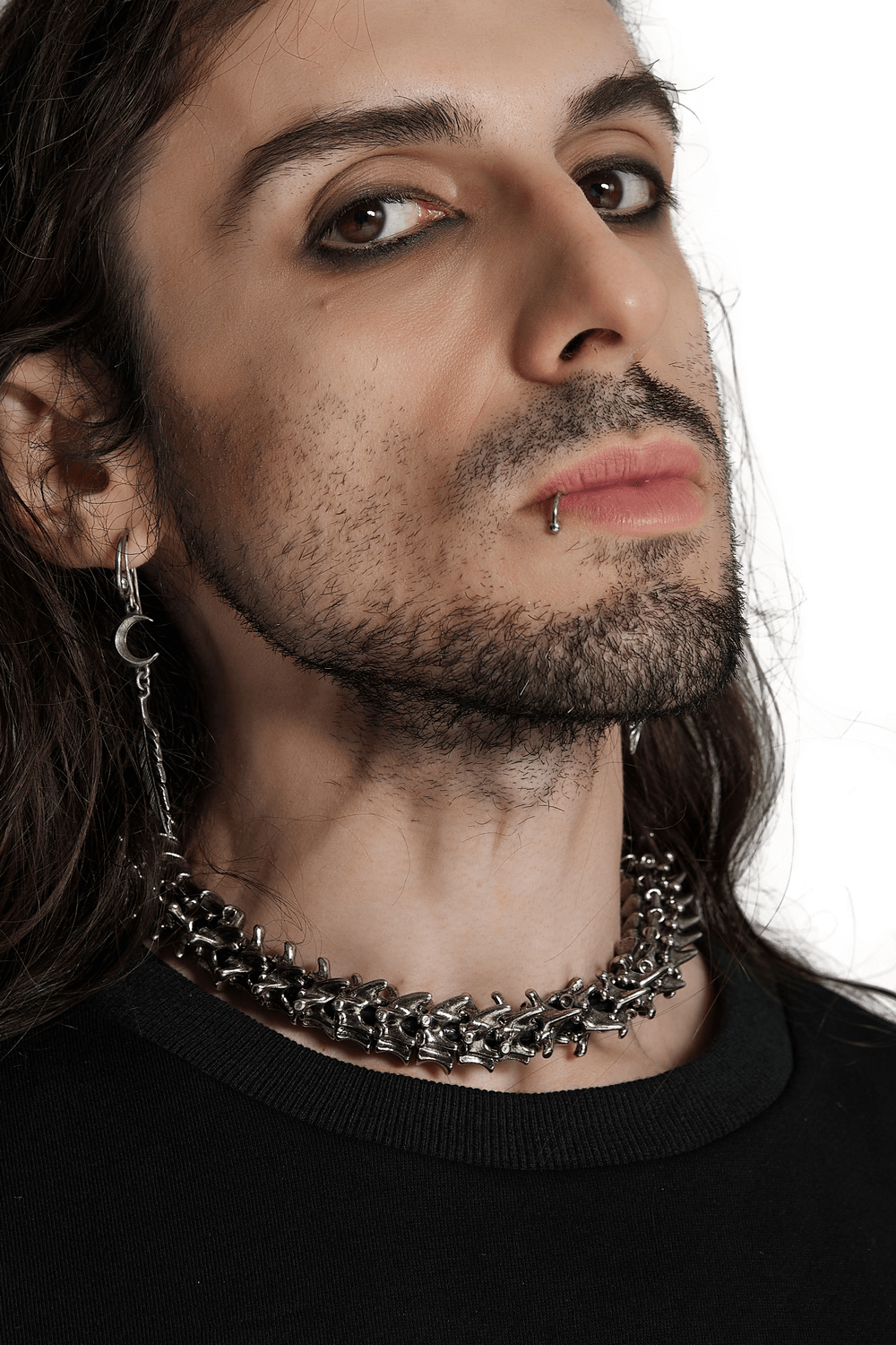 Model showcasing a metallic spine choker with a punk aesthetic and textured finish.