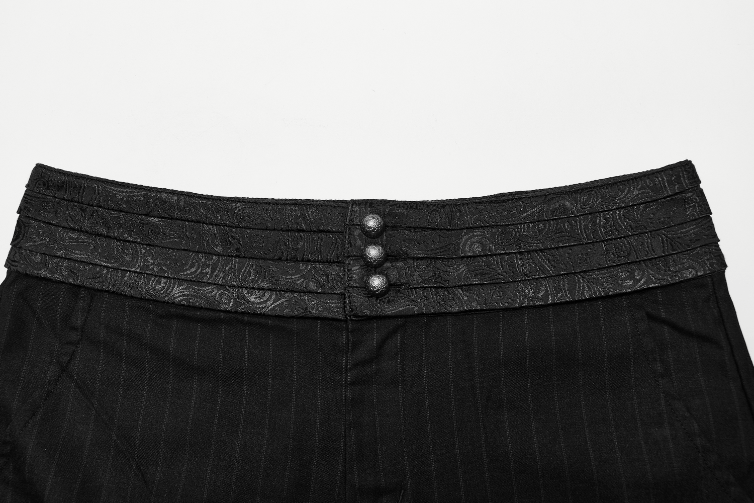 Close-up of the stylish layered waistband with buttons on black striped steampunk pants.