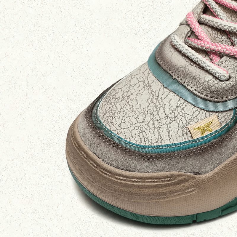 Close-up of women's genuine leather patchwork high sole boot showcasing unique textures and colorful laces.