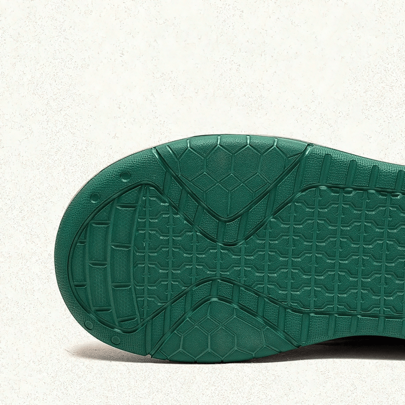 Green textured sole of genuine leather women's patchwork platform boots, showcasing stylish grip and design.