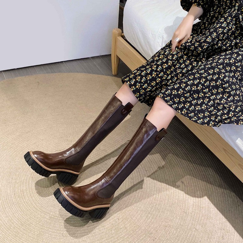 Genuine leather women's brown platform boots with round toe and square heel, paired with a floral dress.