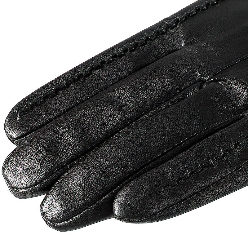 Close-up of genuine leather black sheepskin women's long gloves with stylish stitching details.