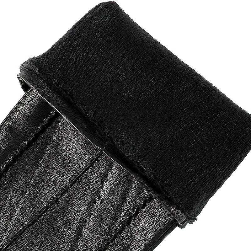 Close-up of genuine sheepskin women's black long gloves with plush cuff, perfect for vintage style winter outings.
