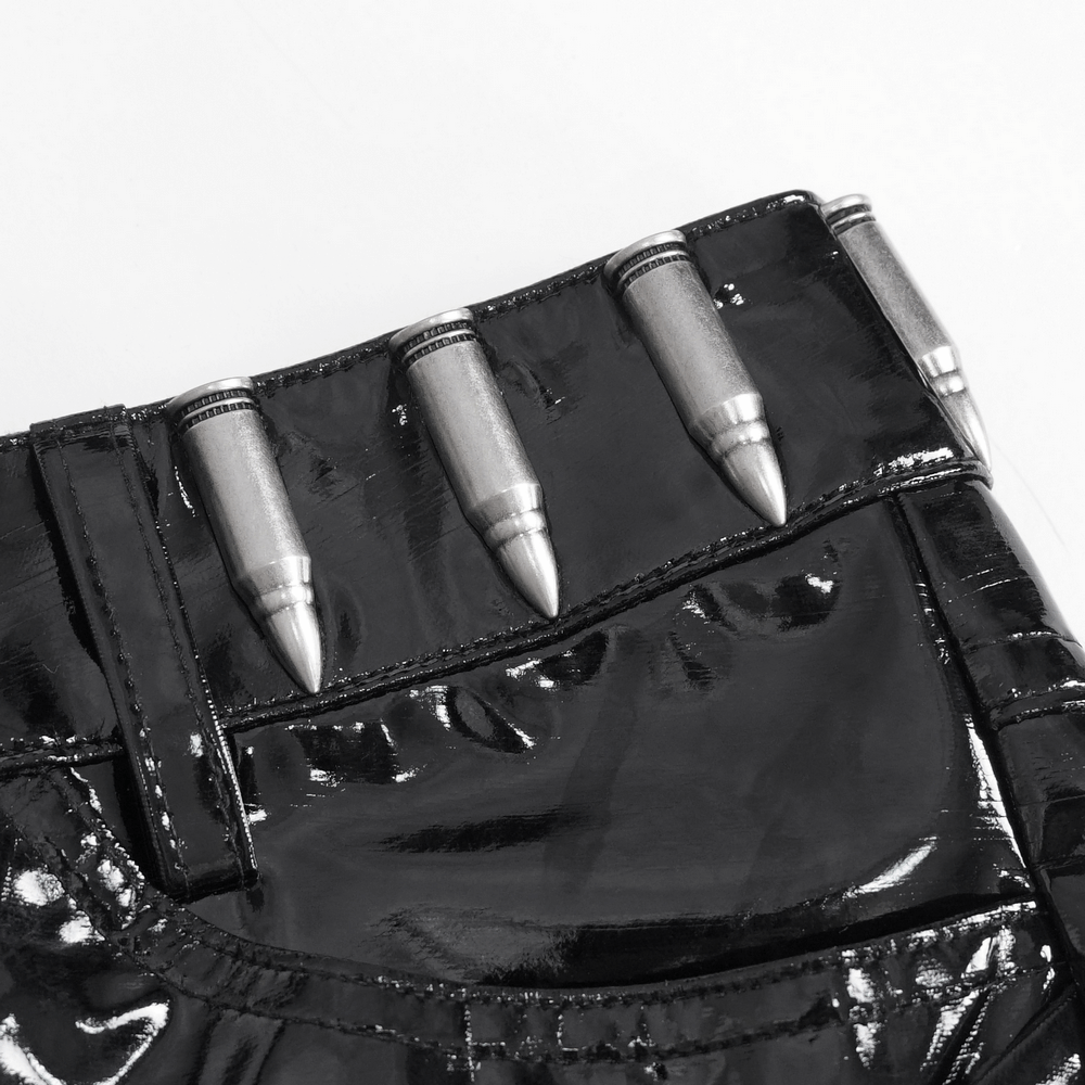 Close-up of glossy black shorts with bullet-like metal accents, embodying punk rock fashion.
