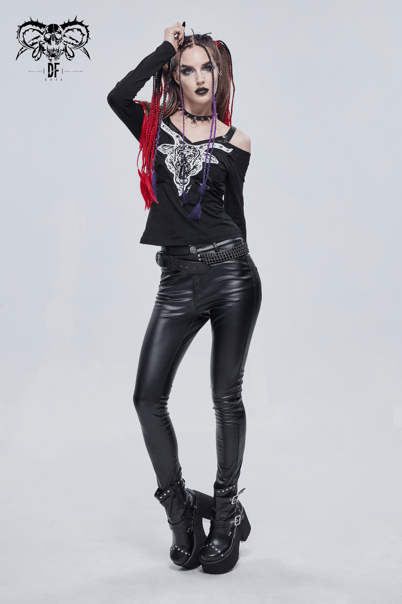 Gothic women's black top with goat skull design and cut-out shoulders, styled with faux leather pants.